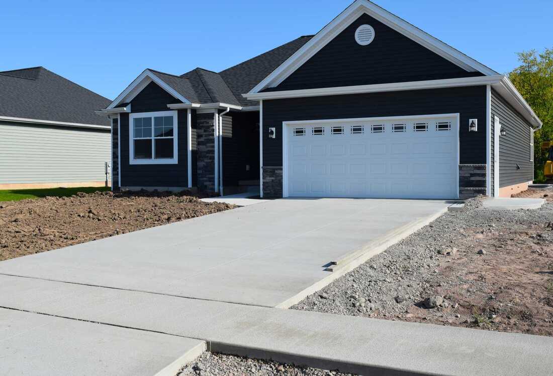 nicely done concrete driveway and patio in palmerston north